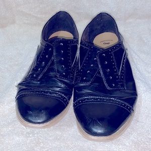 Black faux patent leather oxfords. Well loved & worn.
